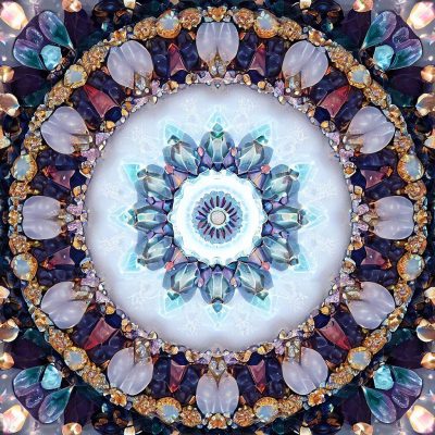 an image of a mandala with crystals and gems arranged in circular patterns.