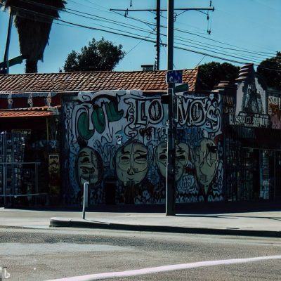 A cholo neighborhood, capturing the streets, the graffiti walls and the iconic places that define the identity of a cholo neighborhood.